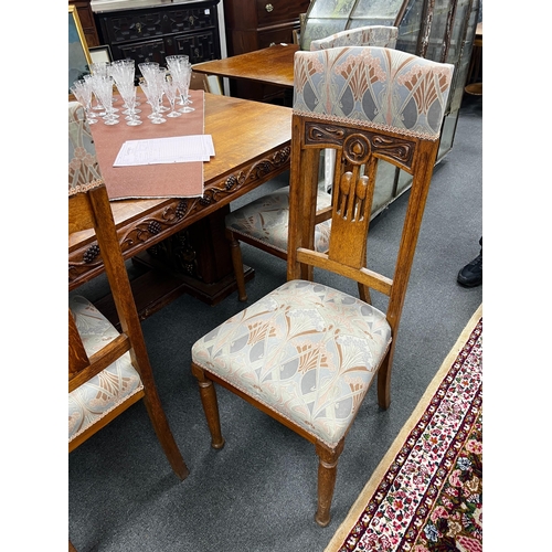 1116 - A set of Art Nouveau carved oak dining chairs, one with arms with original Liberty receipt