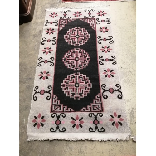 1132 - A Tibetan black ground geometric rug, 164cm x 86cm