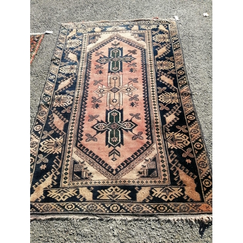 1142 - A Caucasian red ground geometric rug, 188 x 120cm