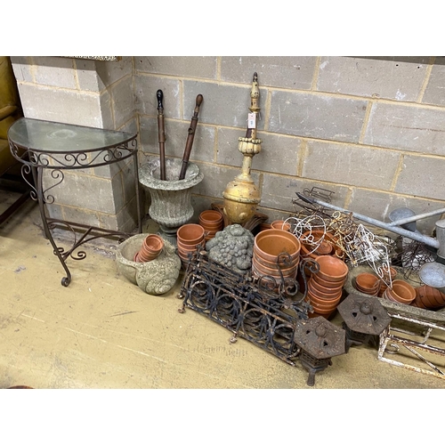 1165 - A large quantity of assorted garden ornaments, terracotta pots, galvanised watering cans, bench ends... 