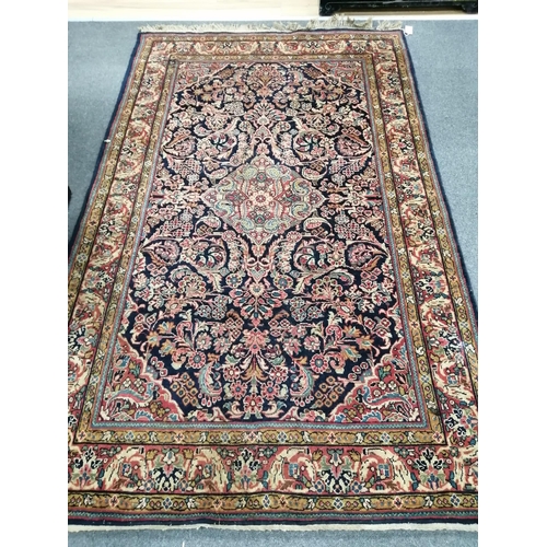 1187 - A Persian blue ground rug, probably Mashad, 210 x 131cm