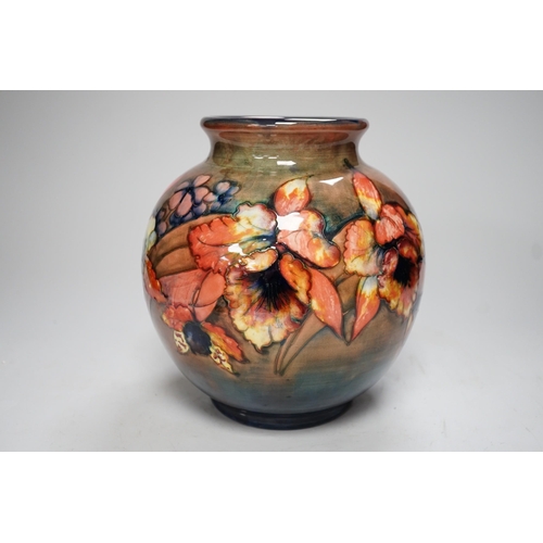 1253 - A Moorcroft flambé orchid globe shaped vase, 21cm