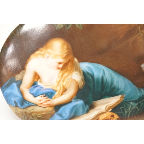 1258 - A 19th century painted porcelain oval plaque of a reclining lady reading a book. The reverse stamped... 