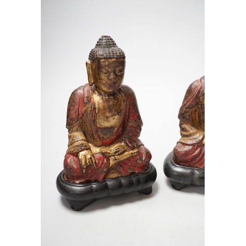 1264 - A set of three Chinese polychrome lacquered wood seated figures of Buddha, 19cm