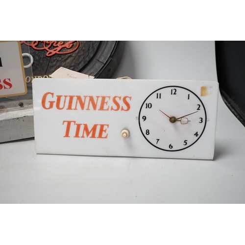 1283 - A Guinness time illuminating timepiece, Guinness display light and a Guinness advertising barrel cov... 