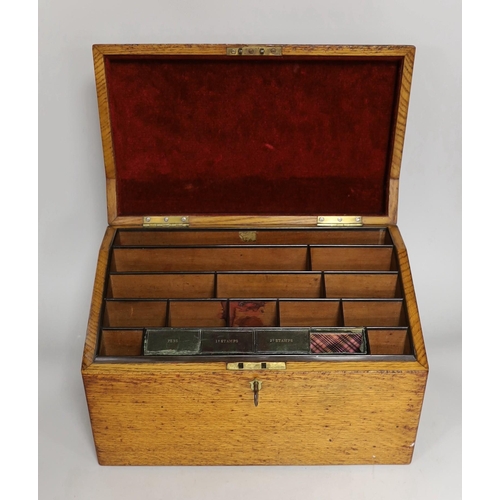 1296 - A 19th century oak stationery casket, with a sectional fitted interior and leather compartment for p... 