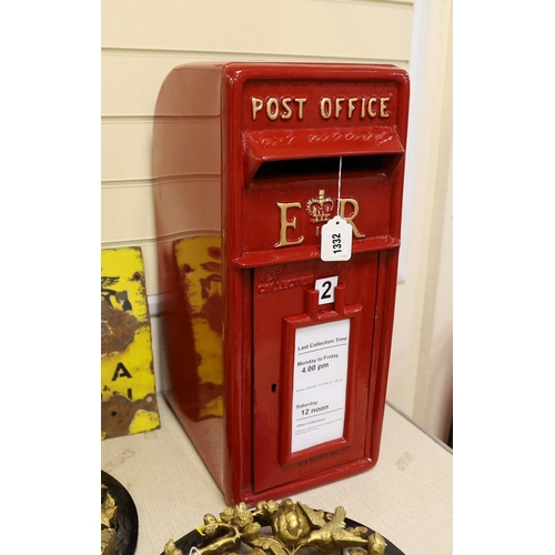 1332 - A Queen Elizabeth II red painted post box, 57cm tall