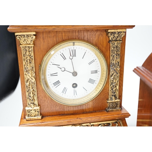 1377 - A Garrard clock and an oak brass mounted clock 29cms high,