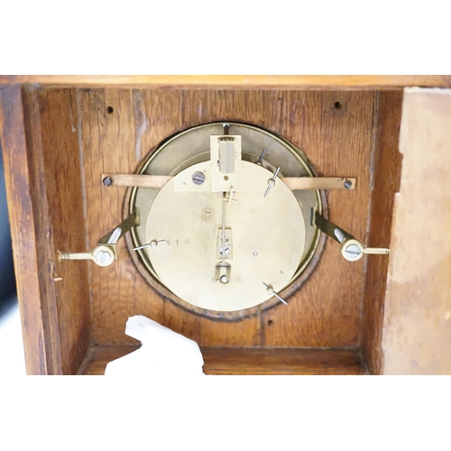 1377 - A Garrard clock and an oak brass mounted clock 29cms high,