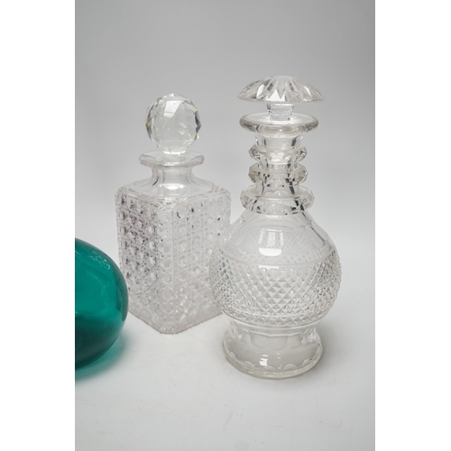 1408 - A green glass decanter flagon, a Bohemian red flash cut carafe (lacking stopper), a pineapple cut gl... 