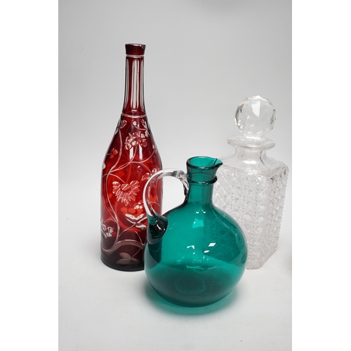 1408 - A green glass decanter flagon, a Bohemian red flash cut carafe (lacking stopper), a pineapple cut gl... 