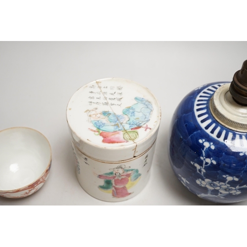 1442 - A 19th century Chinese famille rose cylindrical jar and cover, 11.5cm high, a blue and white prunus ... 