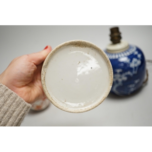 1442 - A 19th century Chinese famille rose cylindrical jar and cover, 11.5cm high, a blue and white prunus ... 