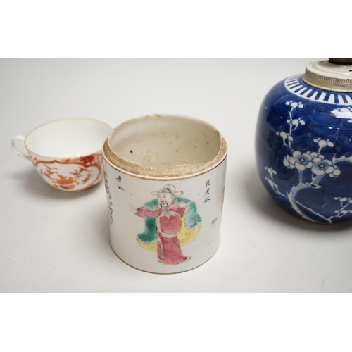 1442 - A 19th century Chinese famille rose cylindrical jar and cover, 11.5cm high, a blue and white prunus ... 