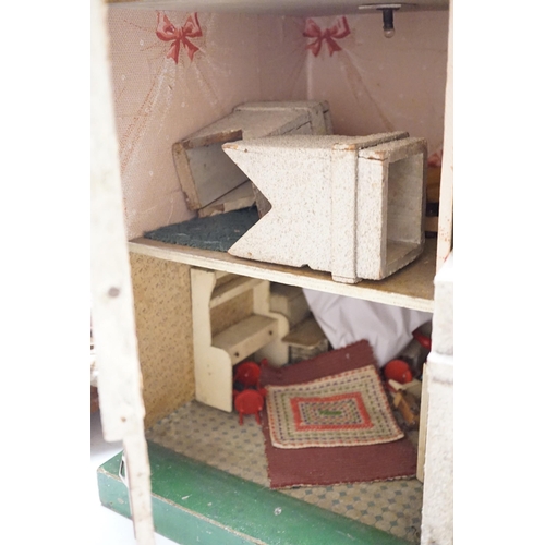 1479 - A Tri-ang dolls house, mid 20th century, with a rough cast facade, a section of half-timbering and ... 