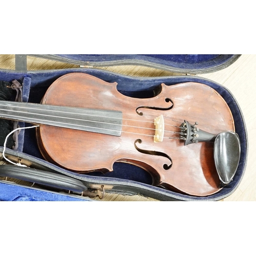 1486 - A violin with carved lion head scroll and two bows in one case