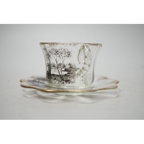 1509 - An unusual Emile Galle enamelled miniature glass cup and saucer. 6cm tall