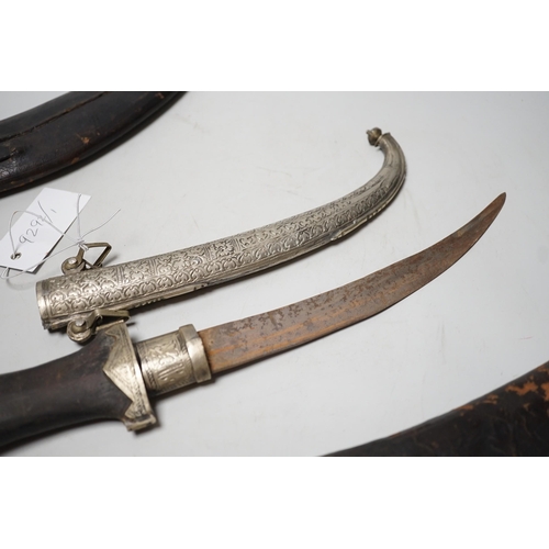 1523 - Two Kukri and eastern daggers, within engraved sheath, (3)