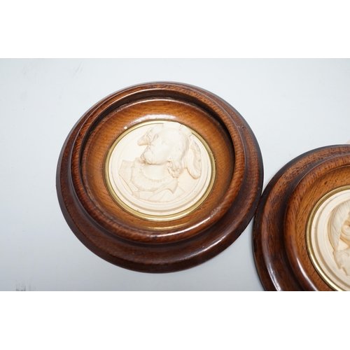 1536 - A pair of late 19th century carved and moulded composition portrait roundels, in oak frames