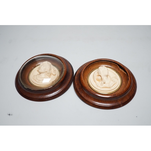 1536 - A pair of late 19th century carved and moulded composition portrait roundels, in oak frames