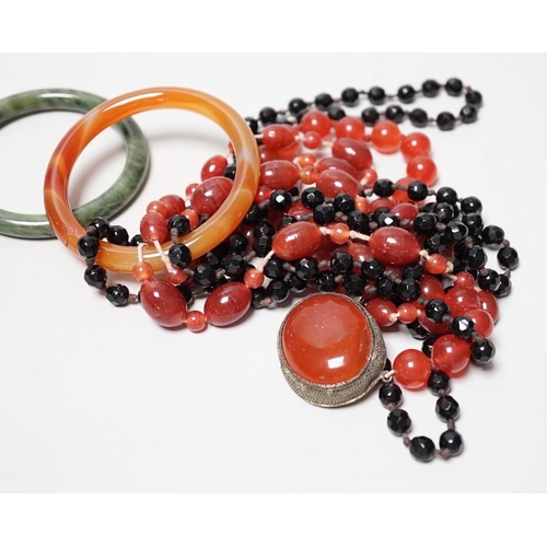 1551 - A spinach green Jade bangle and hardstone bead necklaces