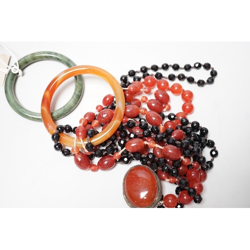 1551 - A spinach green Jade bangle and hardstone bead necklaces