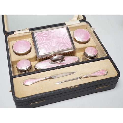 1839 - A cased George V nine piece silver and pink enamel mounted manicure set.