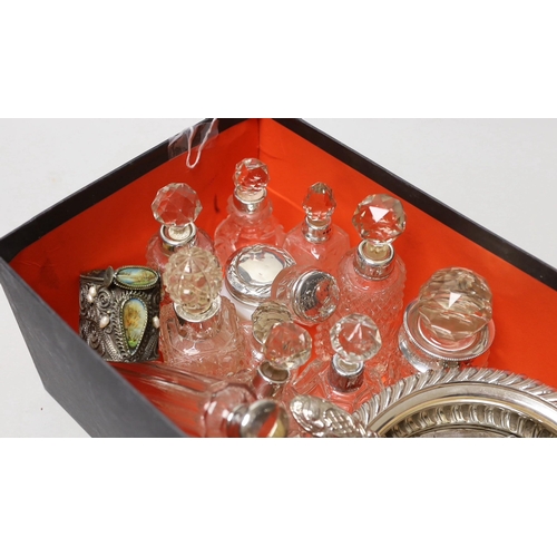 1852 - A collection of assorted silver mounted glass scent bottles and other items including a wine coaster... 