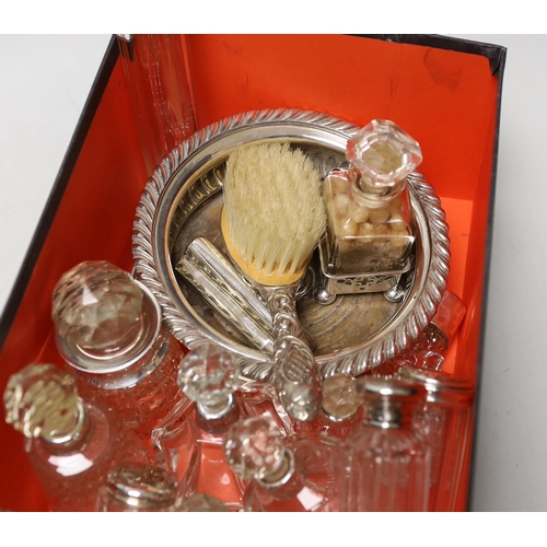 1852 - A collection of assorted silver mounted glass scent bottles and other items including a wine coaster... 