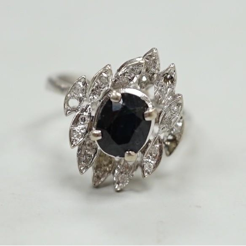 1875 - A modern 750 white metal, sapphire and diamond cluster set dress ring (two diamonds missing), size N... 