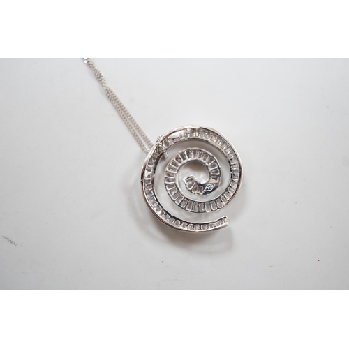 1882 - A modern 750 white metal and baguette cut diamond set whorl design pendant, 22mm, gross 4.5 grams, o... 