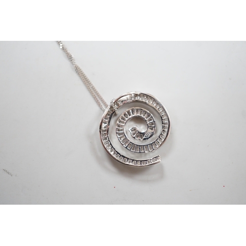 1882 - A modern 750 white metal and baguette cut diamond set whorl design pendant, 22mm, gross 4.5 grams, o... 