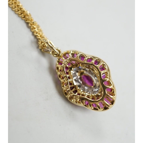 1888 - A modern 18k yellow metal, ruby and diamond cluster set quatrefoil shaped pendant, overall 25mm, on ... 