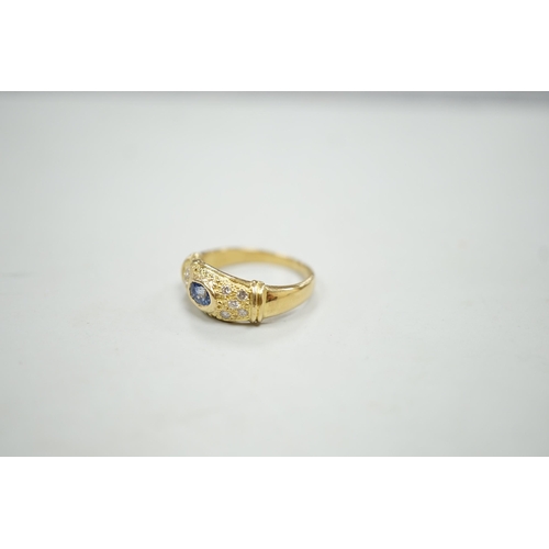 1892 - A modern 18ct gold, single stone oval cut sapphire and ten stone diamond chip set ring, size N/O, gr... 