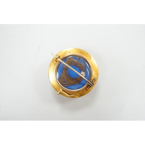 1903 - A cased Victorian yellow metal, enamel and split pearl set circular mourning pendant brooch, the gla... 