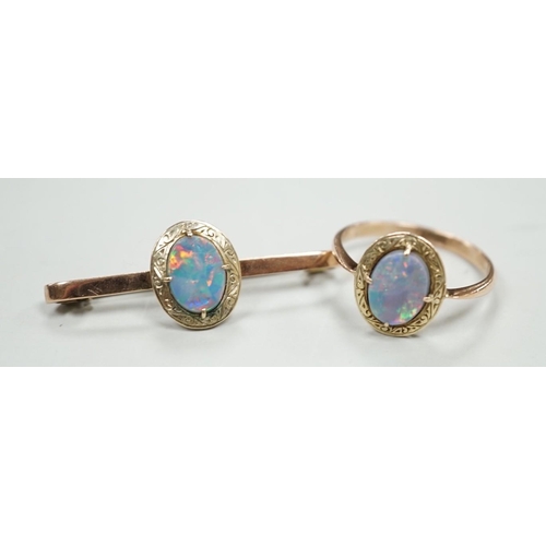 1922 - A 9ct and black opal doublet set bar brooch, 38mm and a matching ring, size R, gross weight 5.9 gram... 