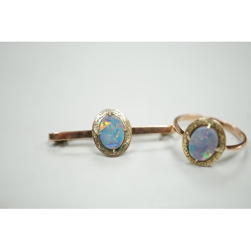 1922 - A 9ct and black opal doublet set bar brooch, 38mm and a matching ring, size R, gross weight 5.9 gram... 