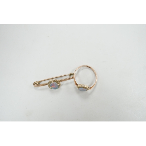 1922 - A 9ct and black opal doublet set bar brooch, 38mm and a matching ring, size R, gross weight 5.9 gram... 