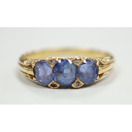 1924 - An early 20th century 18ct and three stone sapphire set half hoop ring, with diamond chip spacers, s... 