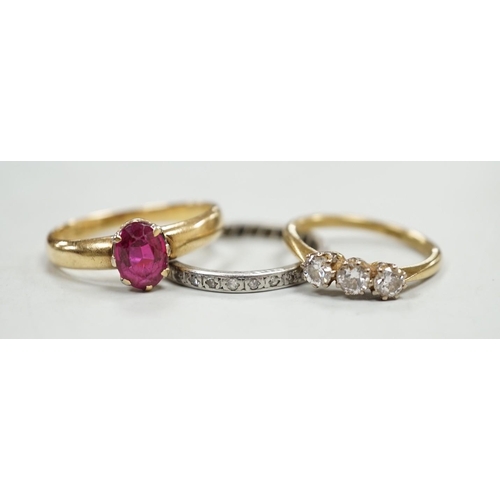 1925 - An 18ct and solitaire synthetic? ruby set ring, an 18ct and three stone diamond ring and a white met... 