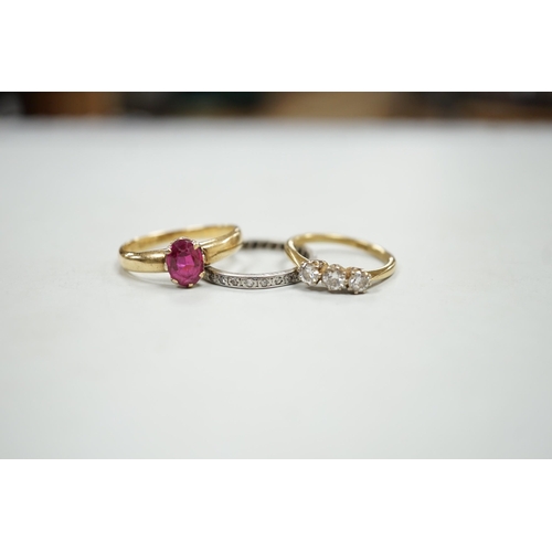 1925 - An 18ct and solitaire synthetic? ruby set ring, an 18ct and three stone diamond ring and a white met... 