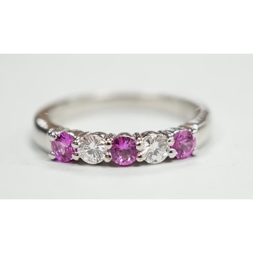 1928 - A modern 18ct white gold, three pink stone and two stone diamond set half hoop ring, size M, gross w... 