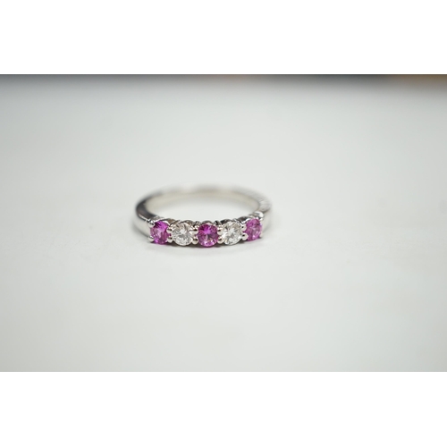 1928 - A modern 18ct white gold, three pink stone and two stone diamond set half hoop ring, size M, gross w... 