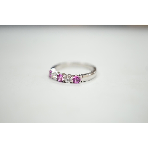 1928 - A modern 18ct white gold, three pink stone and two stone diamond set half hoop ring, size M, gross w... 