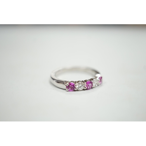 1928 - A modern 18ct white gold, three pink stone and two stone diamond set half hoop ring, size M, gross w... 