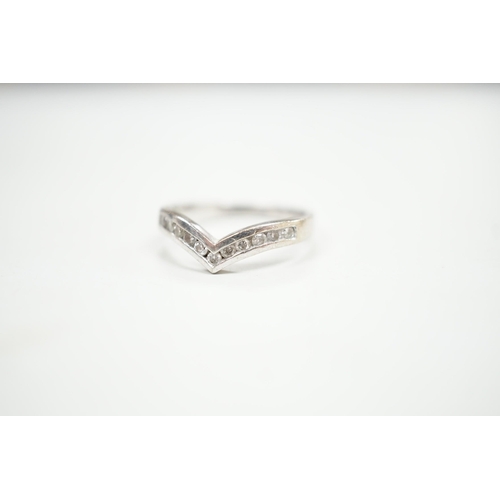 1929 - A modern 18ct white gold and channel set diamond chip wishbone shaped ring, size M, gross 3.4 grams.... 