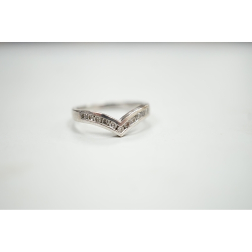 1929 - A modern 18ct white gold and channel set diamond chip wishbone shaped ring, size M, gross 3.4 grams.... 