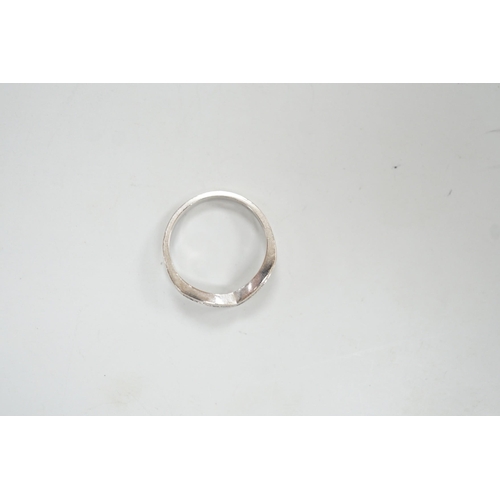 1929 - A modern 18ct white gold and channel set diamond chip wishbone shaped ring, size M, gross 3.4 grams.... 