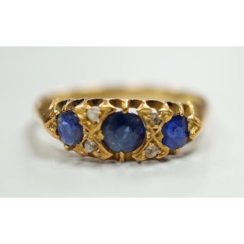 1931 - An Edwardian 18ct gold and graduated three stone sapphire set half hoop ring, with four stone rose c... 