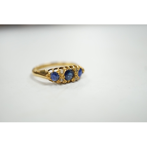 1931 - An Edwardian 18ct gold and graduated three stone sapphire set half hoop ring, with four stone rose c... 